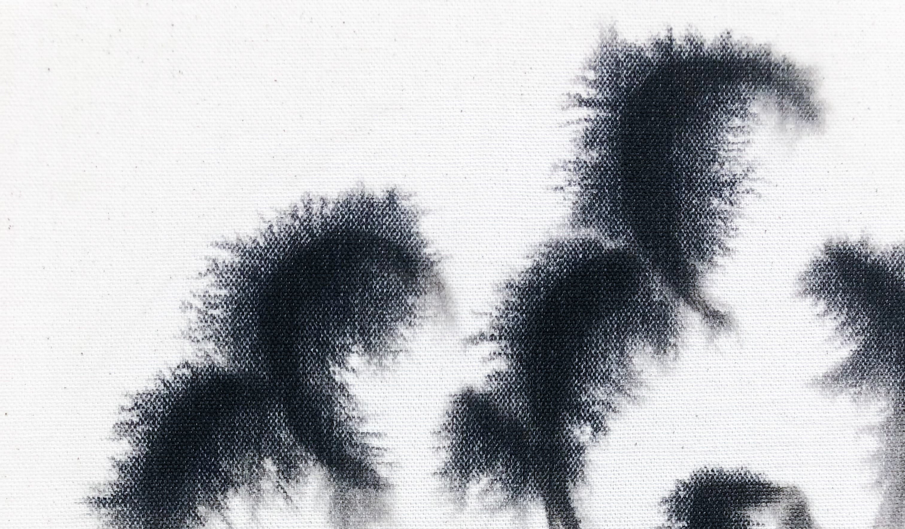 Schwarzer Farbverlauf von Tusche auf einem Textil